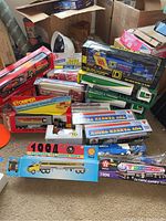 Photo shows a large grouping of boxed diecast toy tanker trucks and semi trucks with various brands and colors including Shell, Citgo, and others.