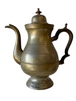 Side view of the pewter coffee pot showing the spout, body, and wooden handle