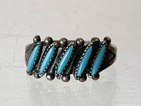 Front view of Native American silver ring with six marquise turquoise stones and silver ball accents nestled between stones.