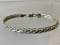 Sterling silver chain bracelet laid flat showing full length and clasp.