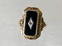 Top view of ring showing black onyx inset with diamond accent