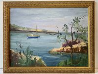 Full view of framed vintage oil painting showing a harbor scene with boat and foliage, signed F.A. Guiddry.