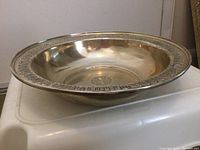 Side view of the Chippendale sterling bowl showing interior shape and decorative rim