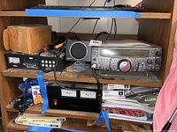 Overall view of shelf with transceiver, speaker, antenna tuner and power supply with cables