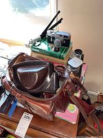 Full lot view with camera bag, manuals, camera, tripod