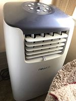 Front view of Newair air conditioner showing adjustable vents and branding