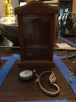 Wooden watch display case front view showing peaked roof top and clear glass panel