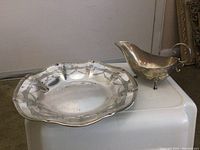 Both sterling silver items displayed together on white platform