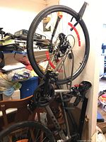 Angled view of bicycle showing front wheel, frame, water bottle cage and mounted locks