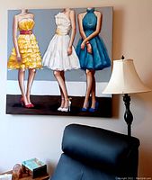 Full view of the large wall painting on canvas hung above furniture and next to a lamp, showing three women in colorful dresses.
