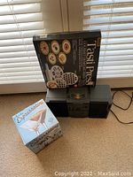 Photo showing the boombox, Tasti Press dumpling press box, and boxed Espressotini martini set together
