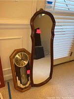 Mirror and clock side by side showing full wood frames and overall size