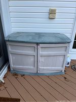 Front view of the large outdoor storage box showing front doors and textured surface