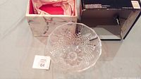 Crystal footed bowl in original packaging with box and tissue paper lining, displaying intricate cut geometric patterns and scalloped rim.