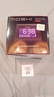 The Moshi digital clock radio in sealed original packaging with the front view showing model IVR006 and display image.
