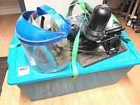 Mastercraft bench grinder, face shield, and blue storage bin packed together with straps