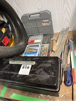 Photo showing gray plastic case with 35-piece Alltrade drill bit set, multiple hand files with wooden handles, and various tools on a workbench.