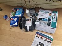 Full lot overview showing all items including back belt packaging, adhesive pads, medical tape, and topical gel.