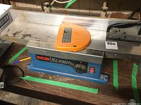 Front-side view of Ryobi bench top jointer planer on workbench.