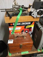 Overall view of plunge router on Black & Decker box with wooden bit case in front