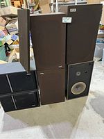 All three pairs of speakers stacked together showing difference in size and finish