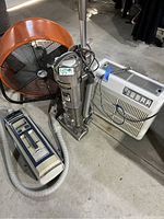 Fan, two vacuum cleaners, and air purifier grouped on floor