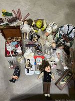 Overview of lot showing dolls, Shrek figure, wooden chest with spools, miniature horses, ladders, and Fisher-Price pull toy phone.