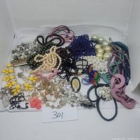 Lot overview showing all 23 necklaces in various colors and styles arranged against white backdrop