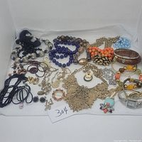 Wide view of all jewelry pieces spread out to show quantity, styles, and condition.