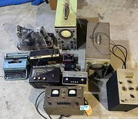 Photo showing all items in the lot including typewriter, sewing machine, oscilloscopes, radio, and testing equipment.