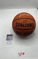 Photo of the signed Spalding All-Star basketball showing Tyrese Maxey's signature in white ink and accompanying JSA authentication card.