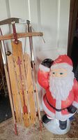 Photo showing whole lot with Santa blow mold and wooden sled side by side