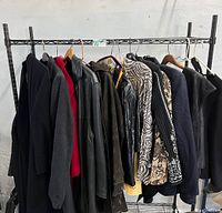 Wide view of 10 various women's jackets on hangers including in black, gray, red, patterned and leather materials