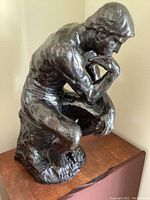 Front three-quarter view of seated figure showing overall form and patina