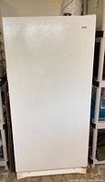Exterior front view of white Kenmore upright freezer