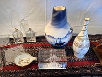Overview of decorative items including vases and ceramics on patterned textile