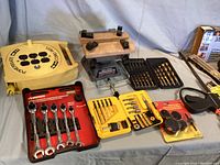 Overview of tools including ratcheting wrench set, vise, and drill bit sets