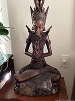 Front view of seated Bodhisattva sculpture on lotus base