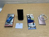 Photo showing all items laid out on a table including two phone stands, 2TB external hard drive with USB cable, and instruction card.
