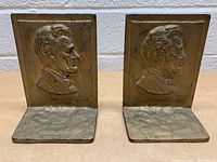 Front view of the pair of bookends showing the Abraham Lincoln embossed profile at the front.