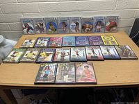 Full view of workout DVDs spread out on a table including various fitness programs and instructional DVDs.