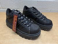 Pair of black Skechers women's shoes size 8, new with tag showing scuff resistant leather material, displayed from side angles