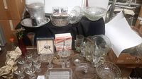 Full table display of bubble glass bar set items including ice bucket, glasses, serving bowls, and other barware