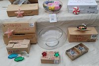 Photo showing boxed floating candle sets with starfish and fish shapes along with a clear glass bowl in center.
