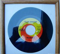 Framed 45 RPM vinyl record single displaying label for "Yellow Submarine."