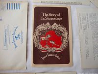 Photo showing booklet titled 'The Story of the Stereoscope' by Stereo Classics Studios Inc. alongside an envelope addressed to Stereoscope Classics.