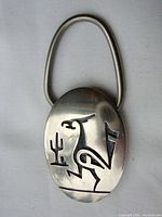 Front of the sterling silver key ring showing an engraved Road Runner design with a cactus.
