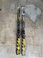 Pair of Atomic SL II skis showing full length from tip to tail, placed on ground indoors.