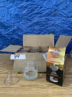 Set of empty Gibson Grey Cup 2012 commemorative glasses in original box and one glass removed for display next to box.