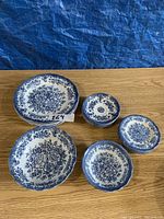 Overall view of 5 pieces including bowls and saucers with blue floral design